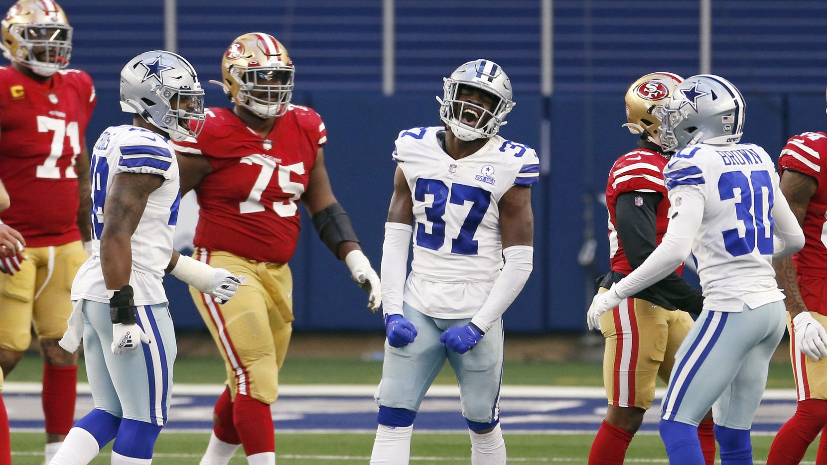 Cowboys safety Donovan Wilson (37) celebrates after intercepting a pass intended for 49ers...