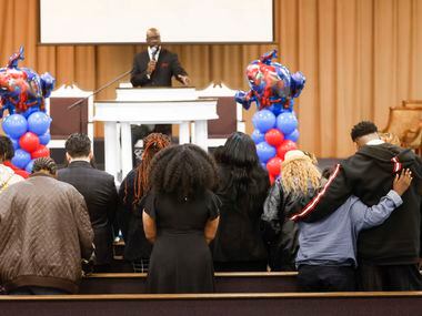 Attendees pray during a funeral service of late Legend Chappell led by pastor Xavier Tippens...
