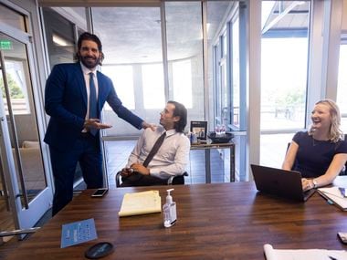From left: Owner and CEO Rogers Healy steps into a meeting to say hi to client relationship coordinators Michael Salerno and Molly Evans on Aug. 11 at the Rogers Healy and Associates office in Dallas.