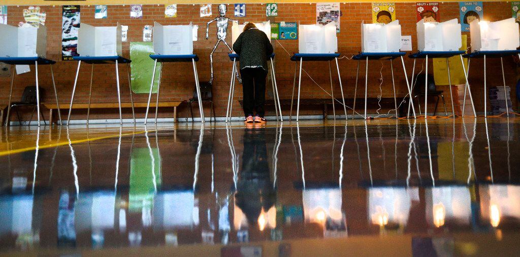 A woman votes at Precinct 4069 in Winnetka Elementary School in Dallas on Nov. 8, 2016.