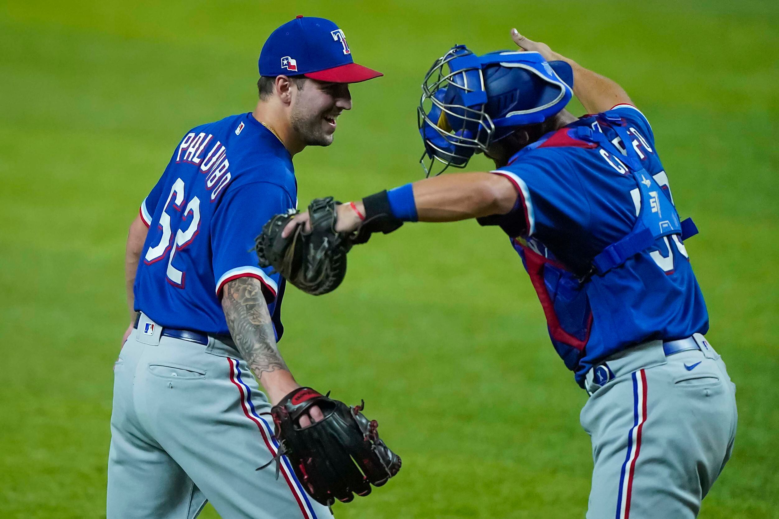 Pitcher Joe Palumbo playfully gets a distanced hug from catcher Nick Ciuffo after recording...