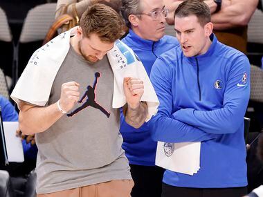 Dallas Mavericks injured guard Luka Doncic pumps his fists as they take a sizable lead late...