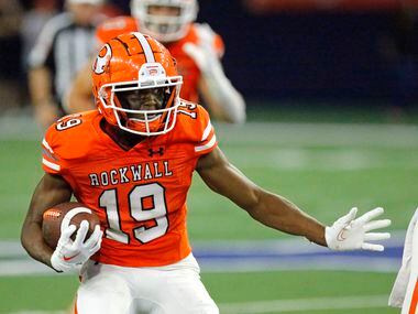 Rockwall High School wide receiver Camron Marsh (19) carries the ball during the first half...