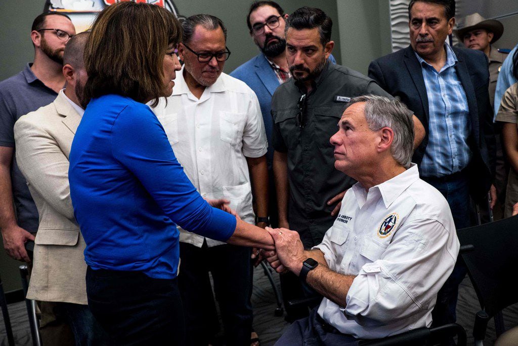 State Rep. Evelina "Lina" Ortega of El Paso shakes the hand of Texas Gov. Greg Abbott after...