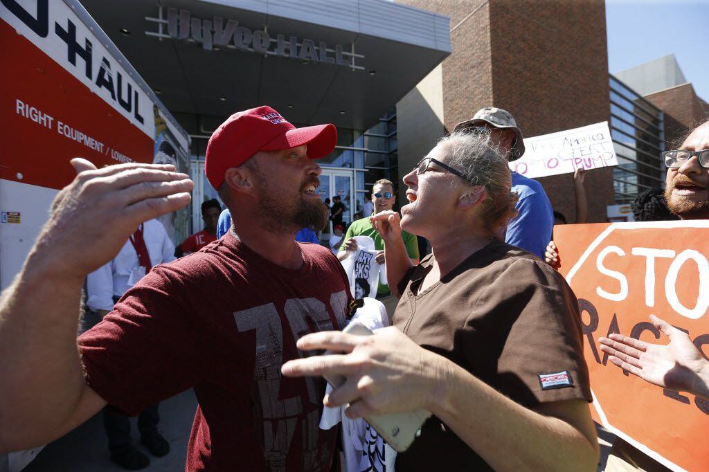 Republican presidential candidate Donald Trump supporter Shawn Behnken, left, and a...