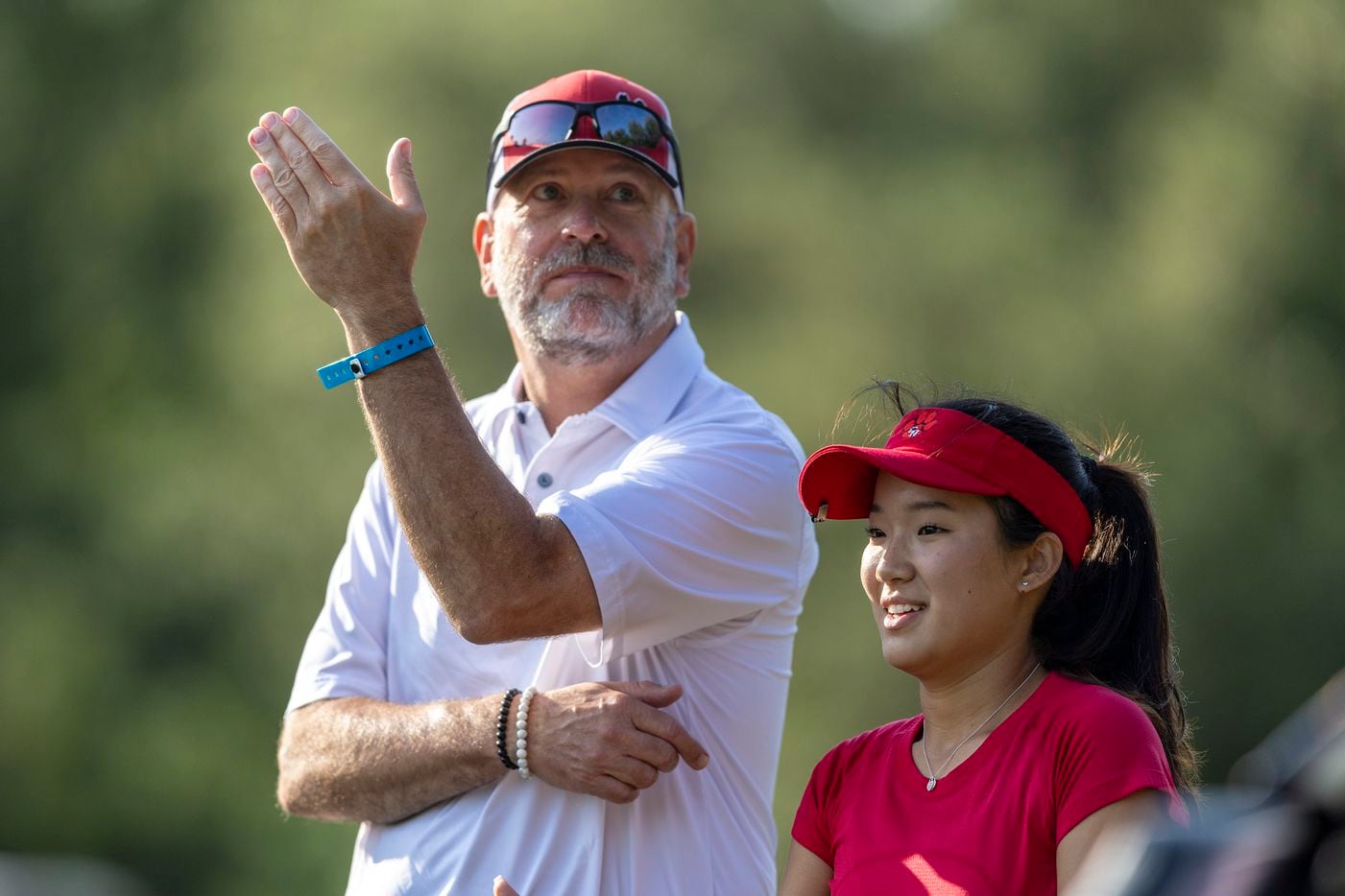 Colleyville Heritage head coach Patrick Nobles speaks with Cindey Xiao on the 3rd tee box...
