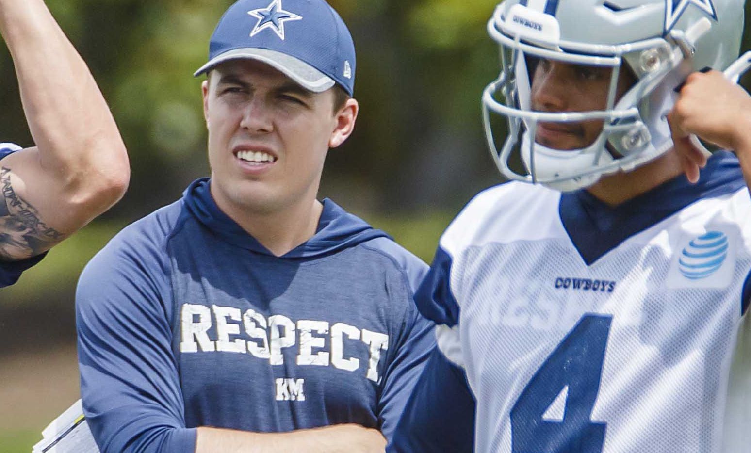 Dallas Cowboys quarterbacks coach Kellen Moore watches a drill with quarterback Dak Prescott...