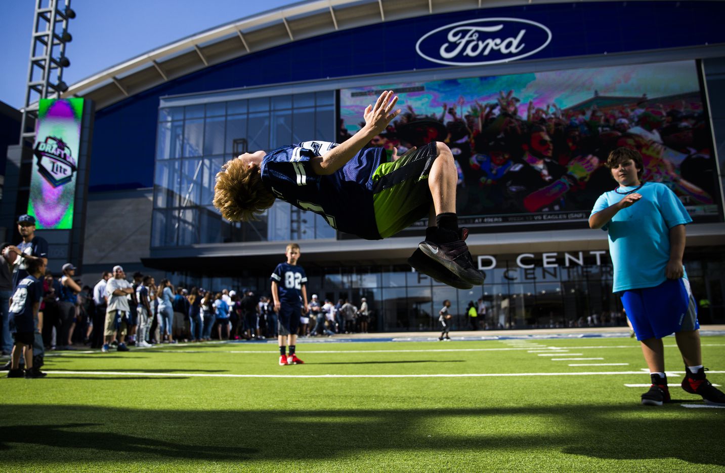 Devon Cohen, 10, does a backflip outside the Dallas Cowboys' 2017 NFL Draft Party on...