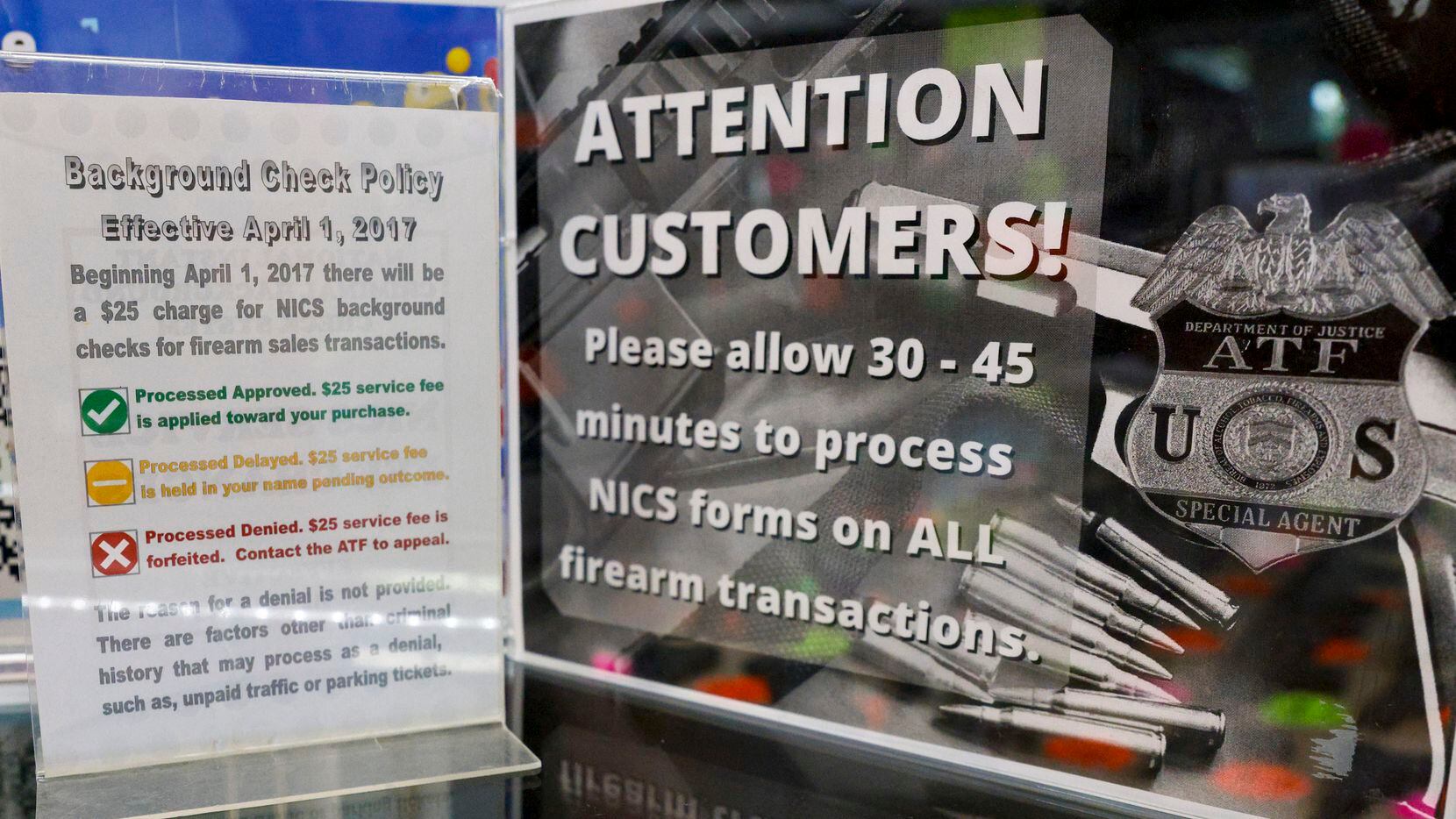 A sign warns customers of the time required for the National Instant Criminal Background...