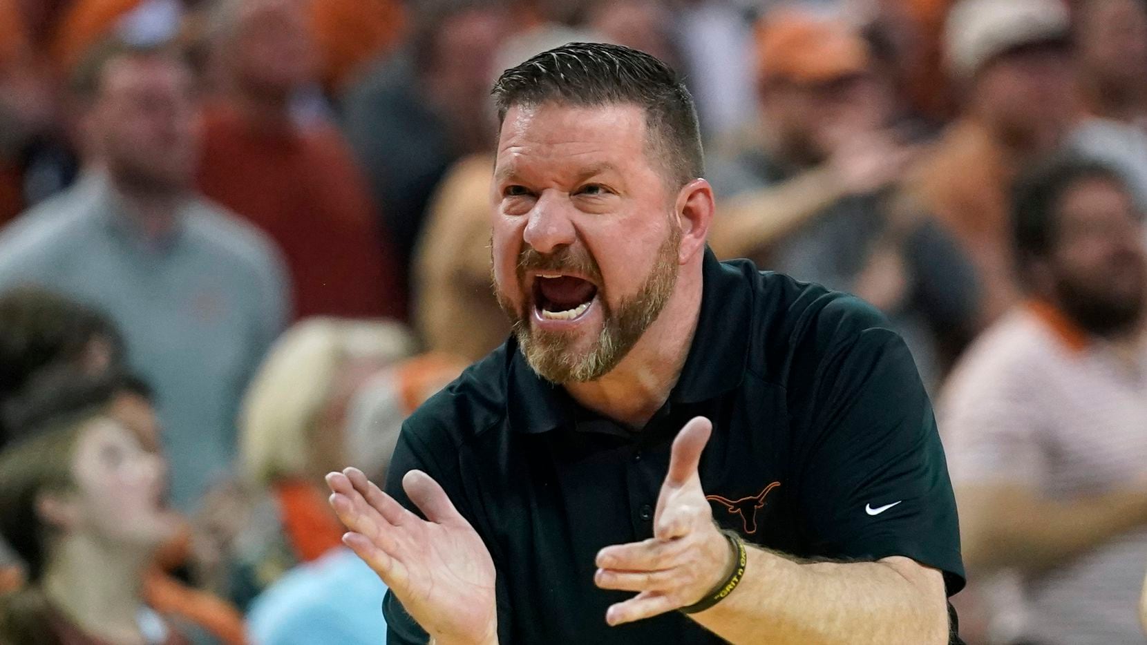 Texas coach Chris Beard talks to players during the first half of an NCAA college basketball...