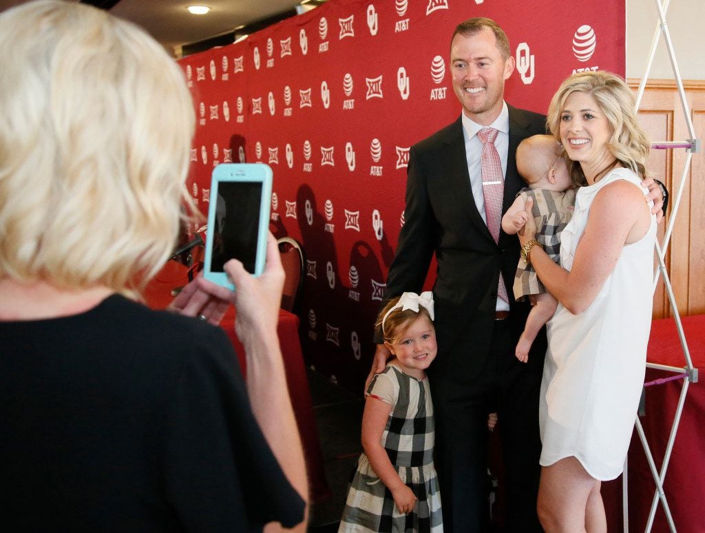 Newly named Oklahoma football coach Lincoln Riley poses for a photo with his familyâwife,...