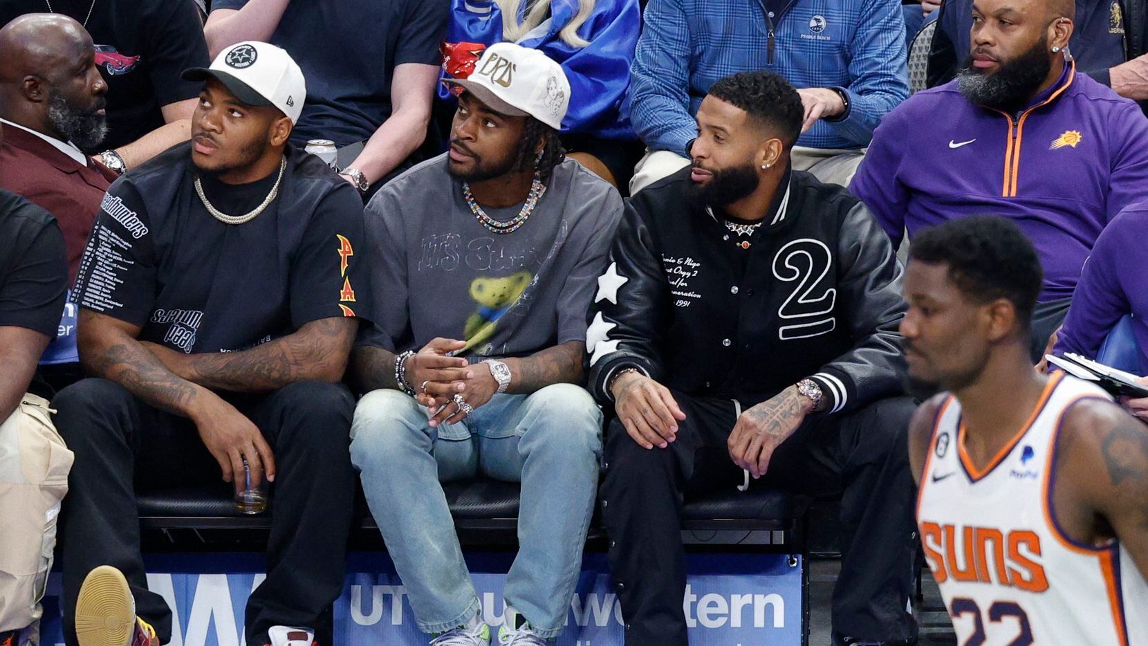 Dallas Cowboys players Micah Parsons (left) and Trevon Diggs sit with NFL free agent Odell...