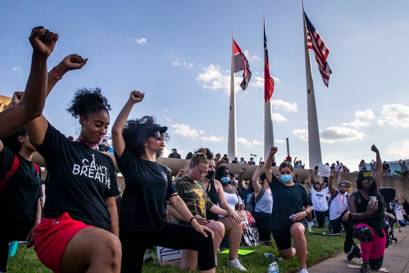 From left, co-organizers Aliyah Russell, Tierra Jenae Giles and other protesters raise their fists while participating in an 8-minute and 46-second kneel in honor of George Floyd during a demonstration at Dallas City Hall to denounce police brutality and systemic racism in Dallas on Thursday, June 4, 2020. The demonstration took place on the seventh consecutive day of organized protests in response to the recent deaths of George Floyd in Minneapolis and Breonna Taylor in Louisville.