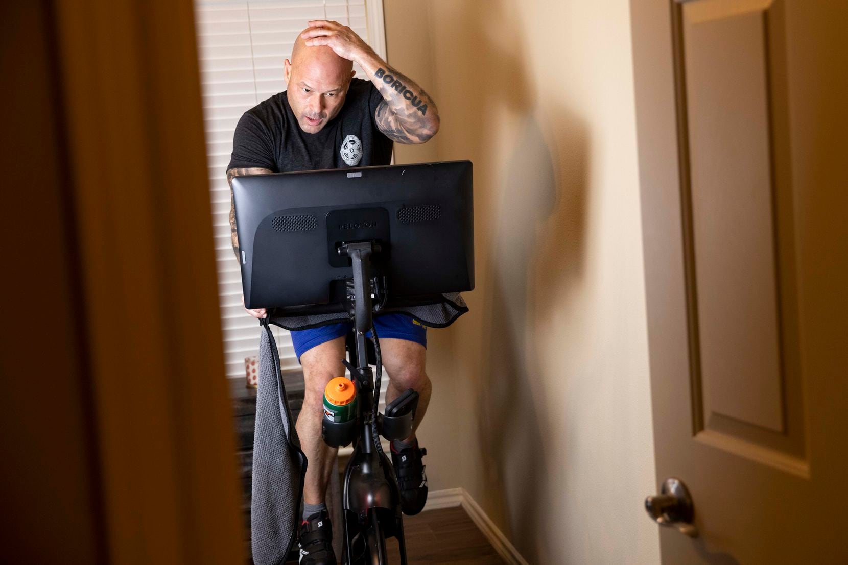 Dallas police Chief Eddie García finishes up his daily workout by doing cardio on his Peleton exercise bike at his home on Thursday, Jan. 27, 2022, in Dallas, TX. 