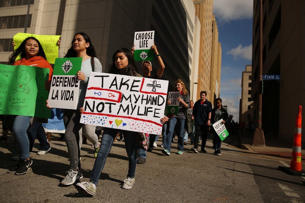 Marchers move through downtown during the North Texas March for Life in Dallas Saturday...