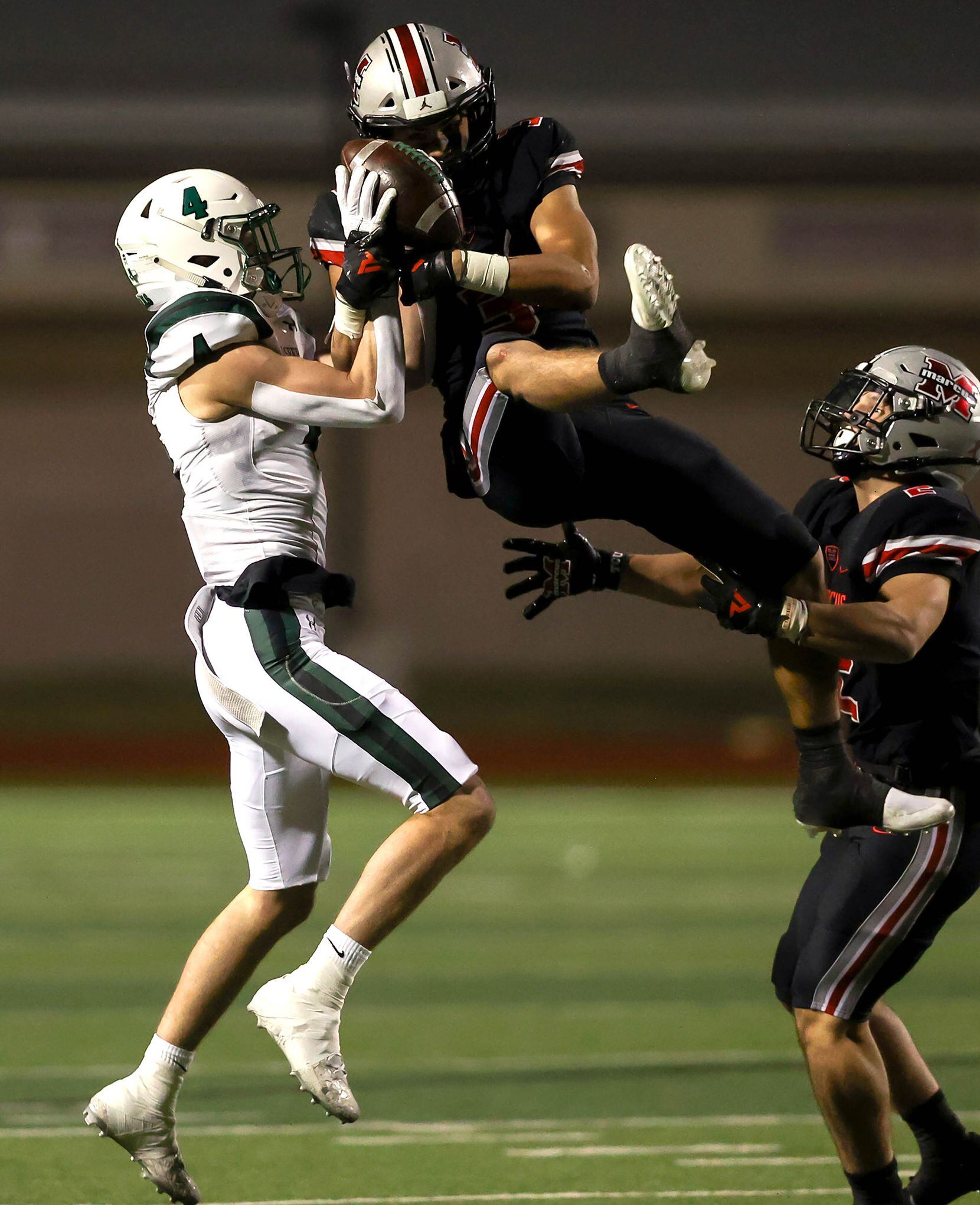 Flower Mound Marcus defensive back Chance Sautter (R) comes up with a interception against...