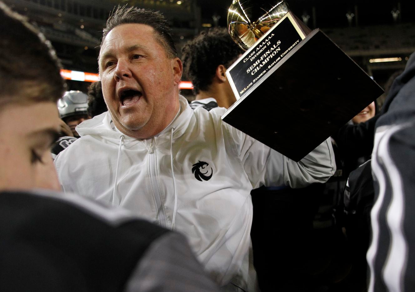 Denton Guyer head coach Rodney Webb hoists the Class 6A Division ll semifinal champion trophy following the Wildcat's 59-14 victory over Tomball to advance to the state final. The two teams played their  Class 6a Division ll state semifinal football playoff game at Baylor's McLane Stadium in Waco on December 11, 2021. (Steve Hamm/ Special Contributor)
