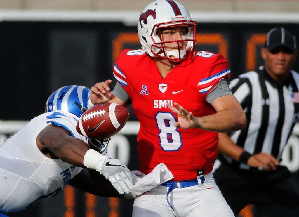SMU quarterback Ben Hicks (8) fumbles as he is hit by Memphis defensive end Latarius Brady (5) in the second quarter during the University of Memphis Tigers vs. the SMU Mustangs NCAA football game at Gerald J. Ford Stadium in Dallas on Saturday, November 5, 2016. (Louis DeLuca/The Dallas Morning News) 