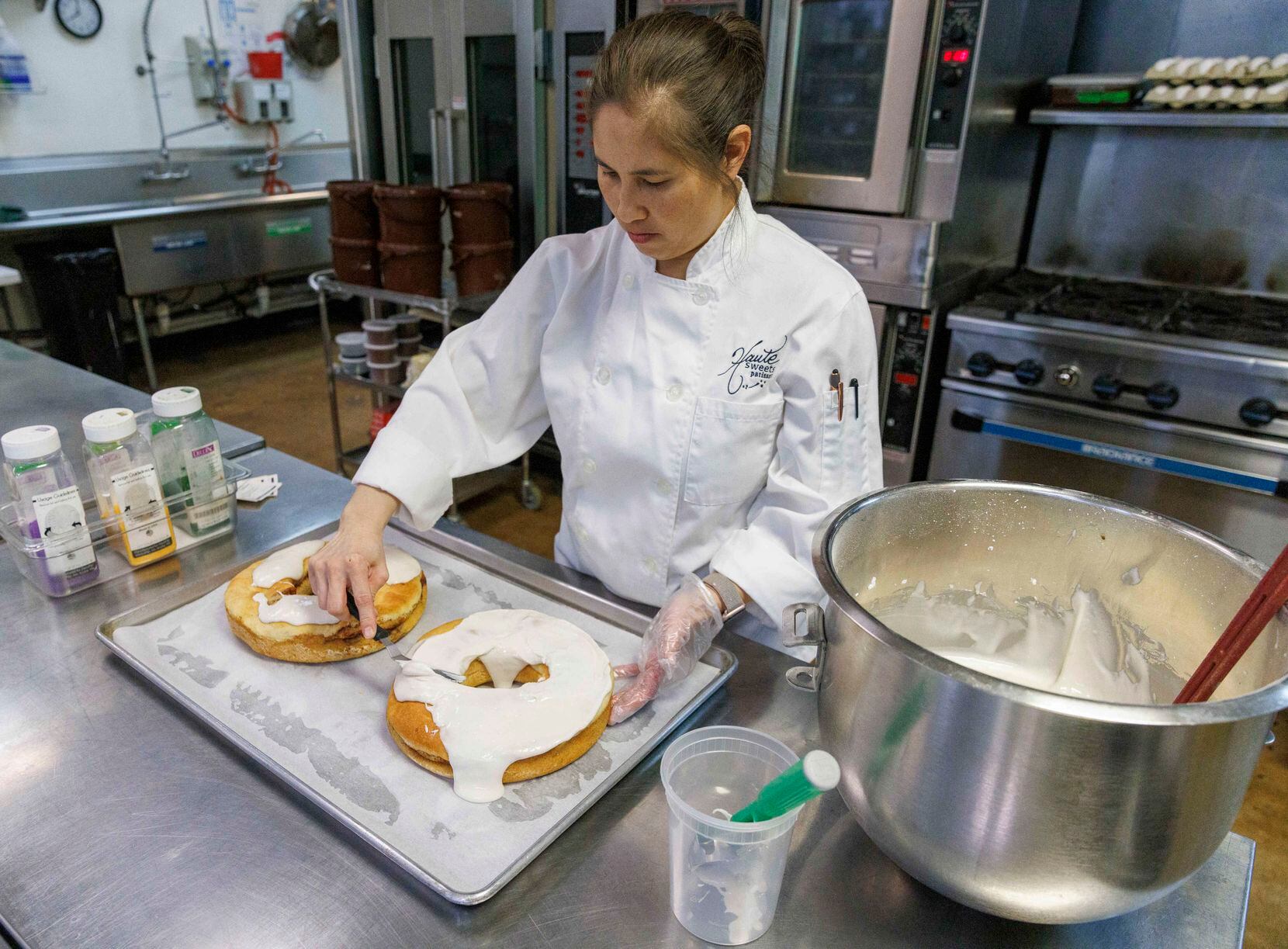 Owner Tida Pichakron ices king cakes at Haute Sweets Patisserie in Dallas.