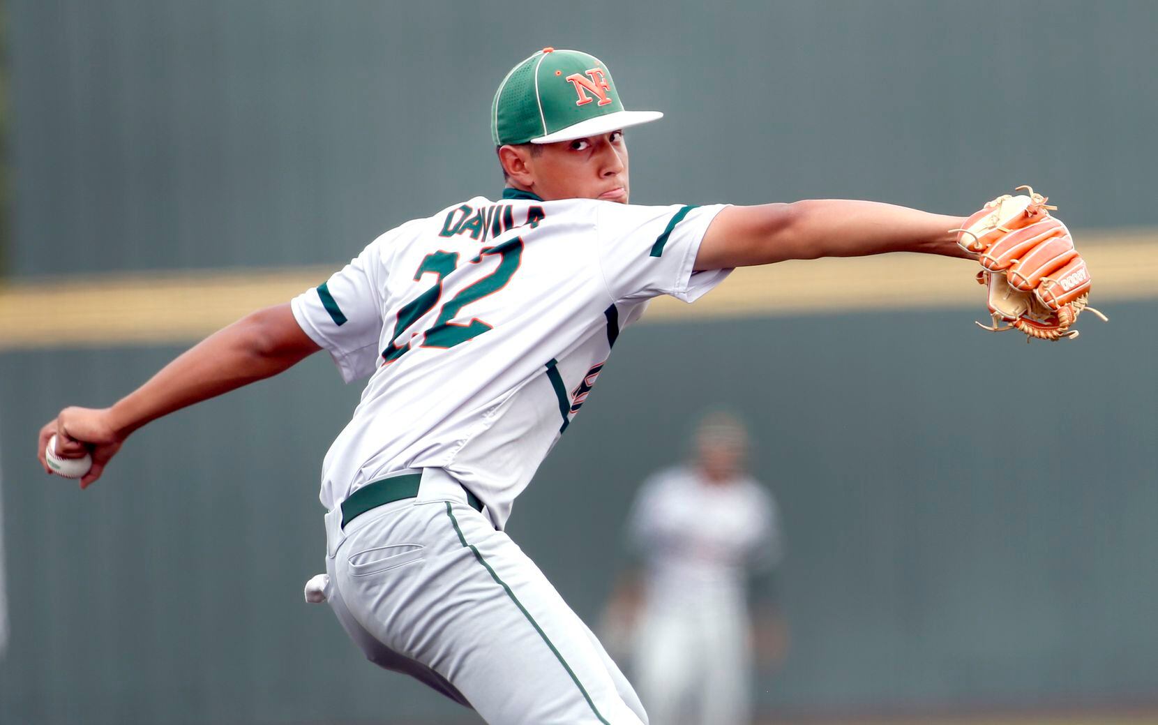 Garland Naaman Forest pitcher Alex Davila (22) delivers a pitch to a Rockwall batter during...
