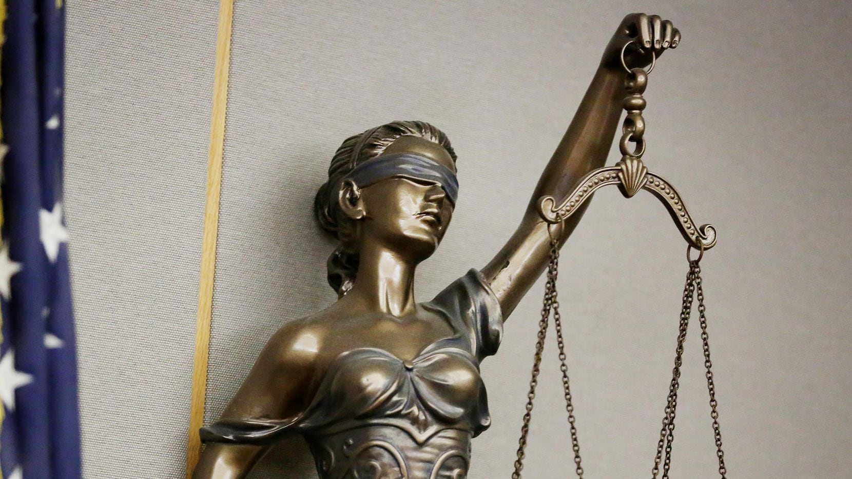 A statue of Lady Justice in a courtroom in the Frank Crowley Courts Building in Dallas on...