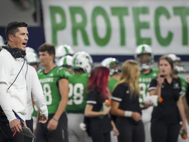 Southlake Carroll head coach Riley Dodge works on the sidelines during the first half of a high school football game against Highland Park at AT&T Stadium on Thursday, Aug. 26, 2021, in Arlington.