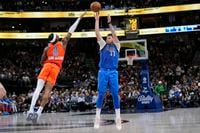 Dallas Mavericks guard Luka Doncic (77) shoots against Oklahoma City Thunder guard Shai...