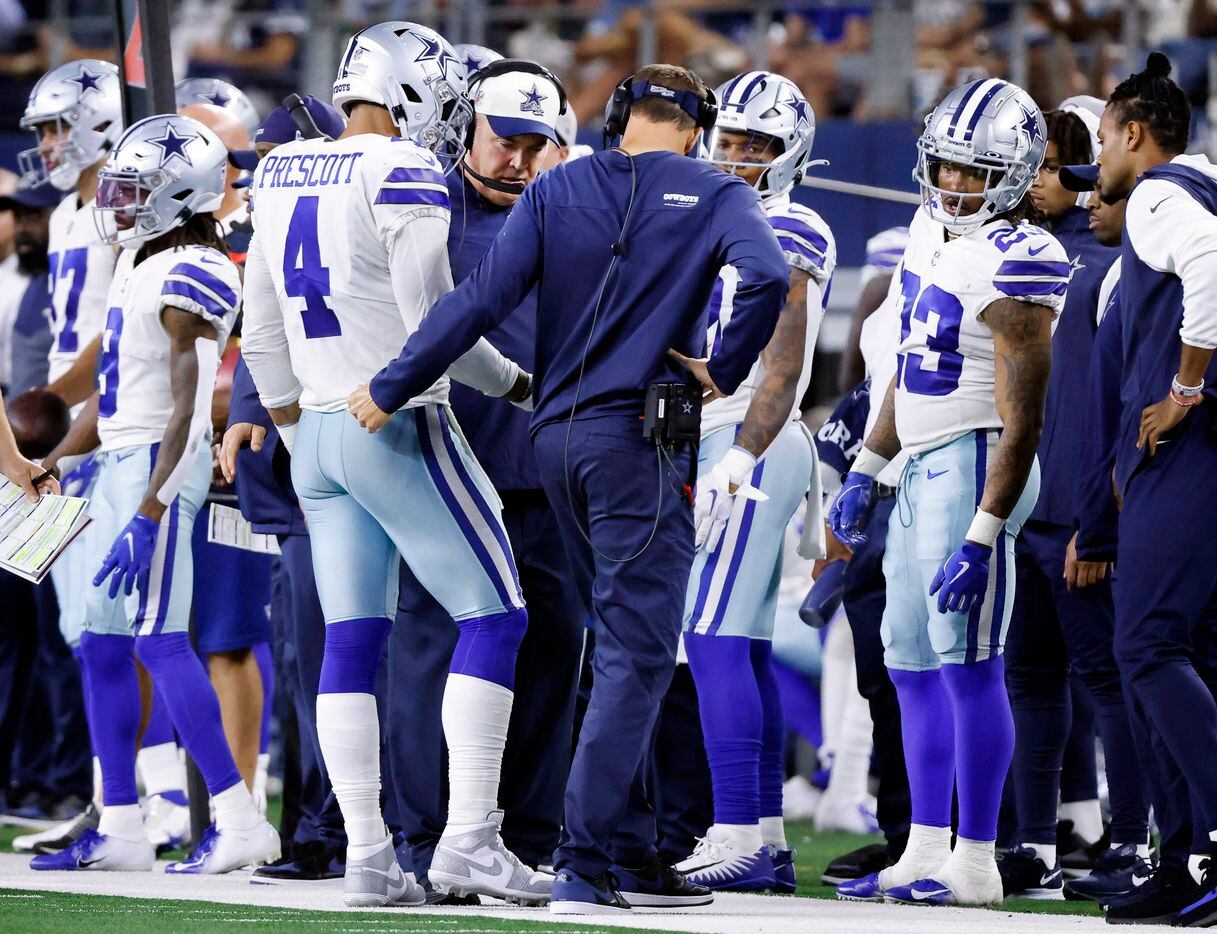 Dallas Cowboys quarterback Dak Prescott (4) shows his throwing hand to head coach Mike...