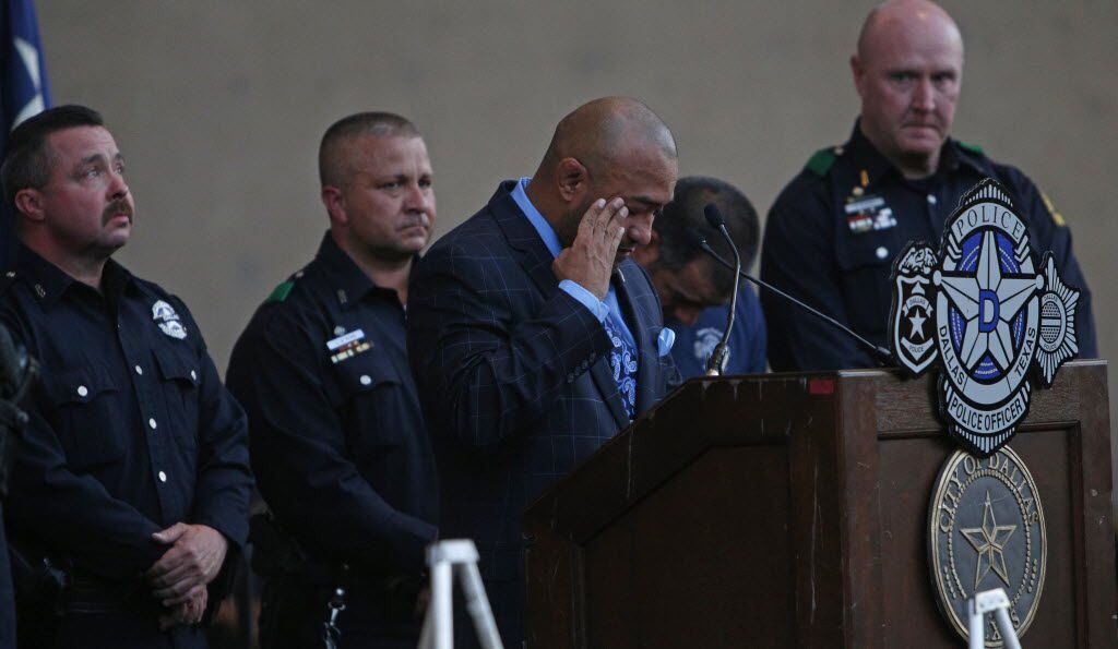 DPD Senior Corporal Castro #7634 speaks on behalf of Senior Corporal Ahrens #8193  during a candlelight vigil hosted by the Dallas Police Association at Dallas City hall in Dallas, TX July 11, 2016. (Nathan Hunsinger/The Dallas Morning News)