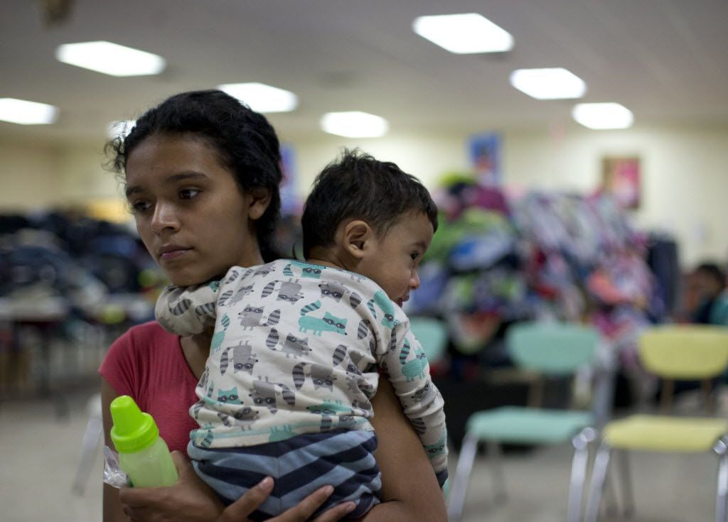 Rosa Danubia Maldonado of Honduras held her child at the Sacred Heart Catholic Church in McAllen in January. Maldonado, 18, was processed by U.S. immigration authorities, who placed a monitor on her ankle before she was allowed to leave. (File Photo/The Associated Press)
