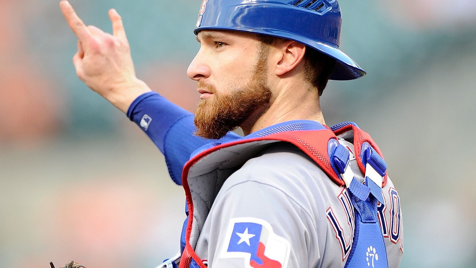 BALTIMORE, MD - AUGUST 02:  Jonathan Lucroy #25 of the Texas Rangers motions that there are...