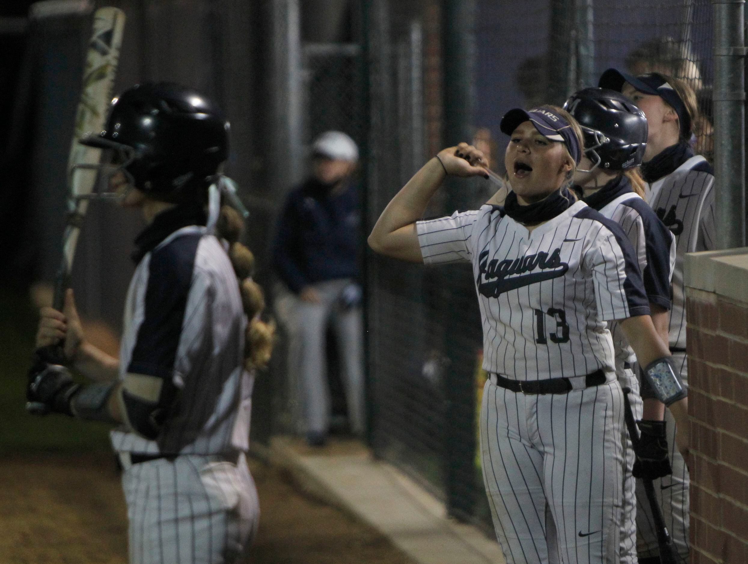 Flower Mound pitcher Karson Hassan (13) delivers vocal support to teammates from the dugout...