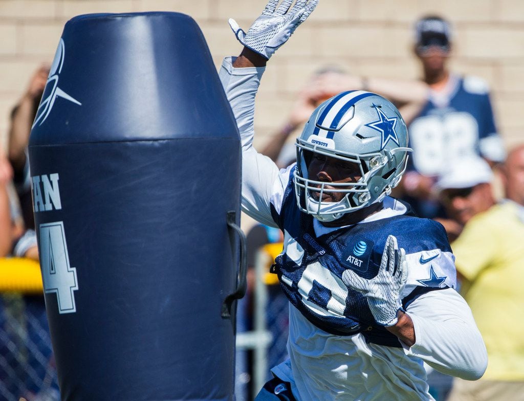 Dallas Cowboys defensive end Robert Quinn (58) attacks a dummy during an afternoon practice...