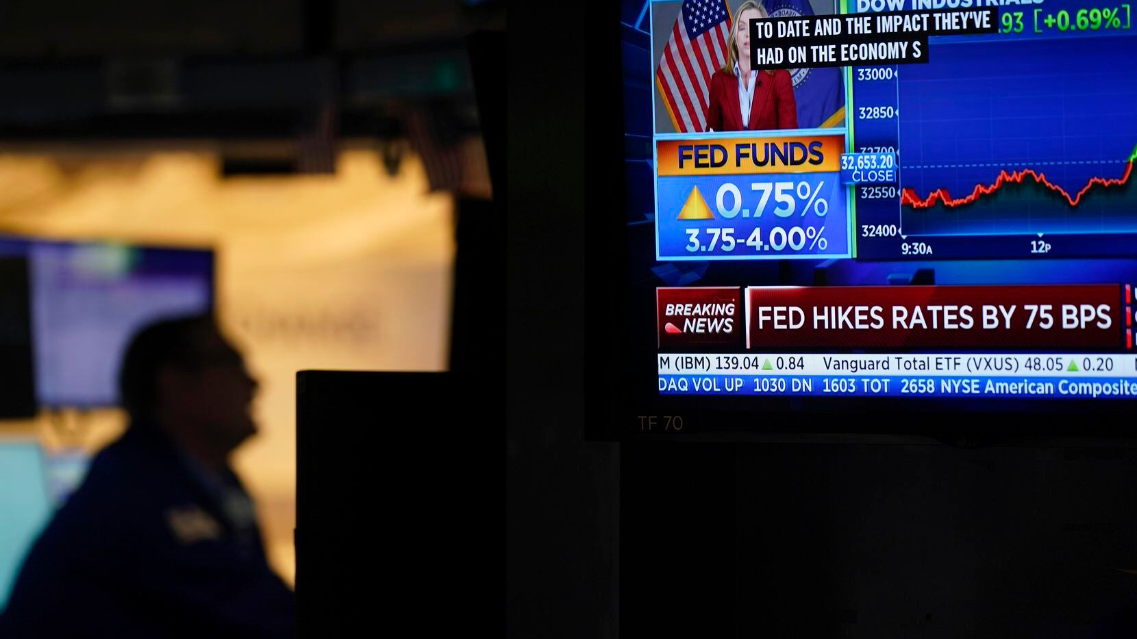 Traders work on the floor at the New York Stock Exchange as the Federal Reserve makes an...
