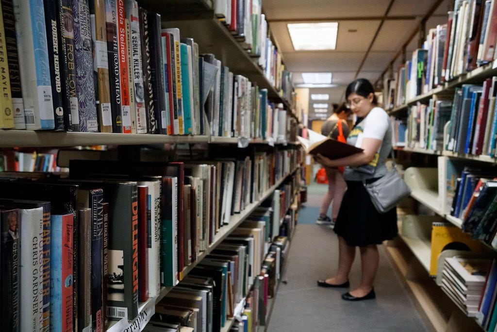 Priscilla Escobedo peruses the bookshelves during the Summer in the City discussion as part...
