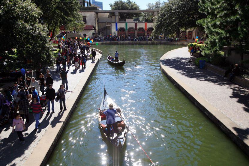 Gondolas move along the water before stopping for passengers at the revived Canal Fest, on...