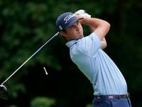 J.T. Poston hits off the second tee during the third round of the John Deere Classic golf...