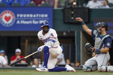 Texas Rangers right fielder Adolis Garcia (53) falls to the ground after a swing during the...