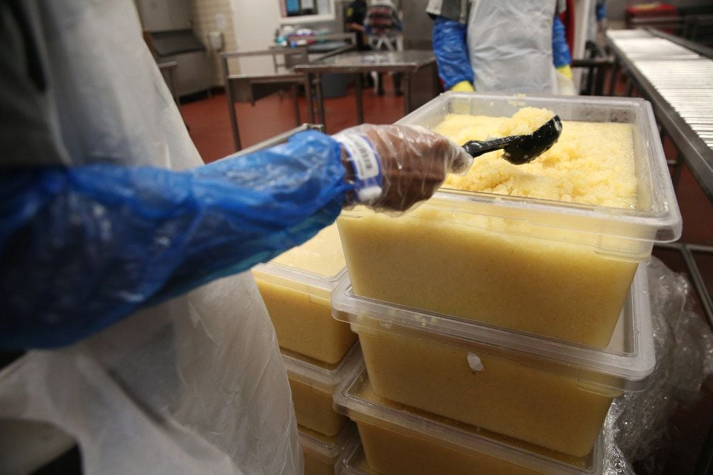 An inmate serves pineapple at the Lew Sterrett Justice Center in Dallas. 