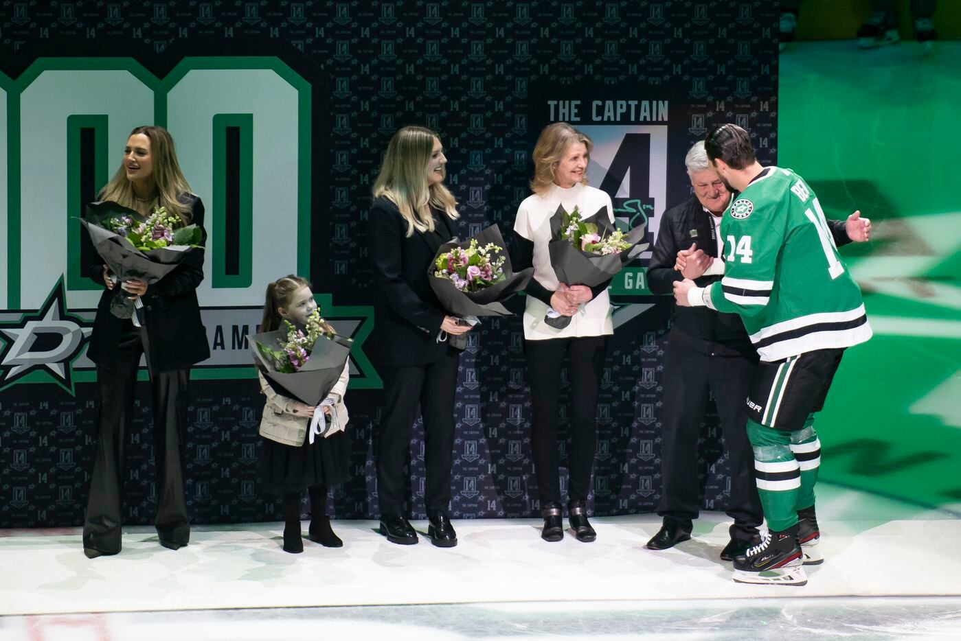 Dallas Stars left wing Jamie Benn (14) hugs his father, Randy, during a ceremony prior to an...