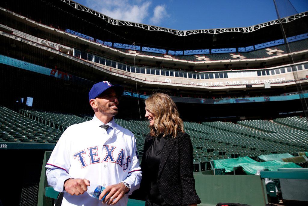 Texas Rangers' new manager Chris Woodward stands with his wife Erin Woodward after a press...