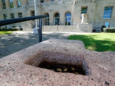 The cornerstone at city hall where Old Rip, a legendary petrified horned lizard, was...