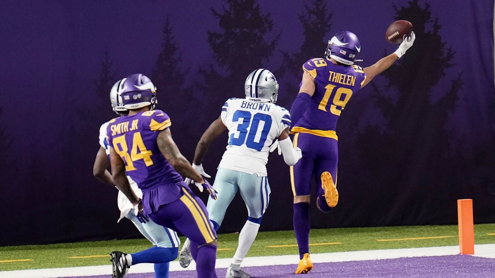 Minnesota Vikings wide receiver Adam Thielen (19) catches a 2-yard touchdown pass ahead of...