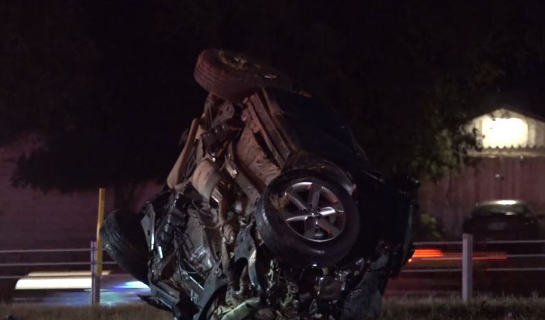 An SUV lies overturned along Loop 820 after its driver was killed Wednesday morning in a head-on collision with an 18-wheeler.