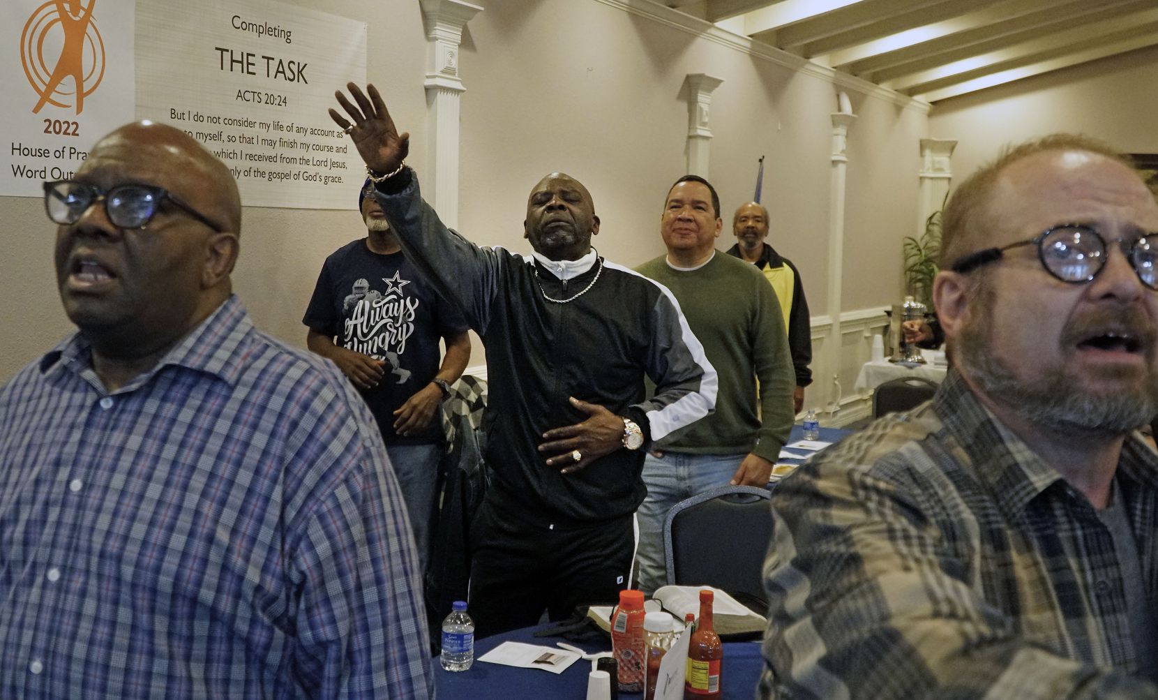 Ernest Lawrence participates in worship service during a monthly breakfast at Restoration...