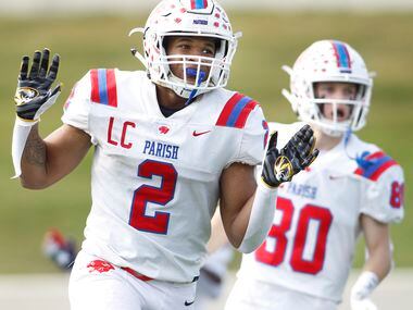 Parish Episcopal running back Andrew Paul (2) celebrates after scoring one of his three...