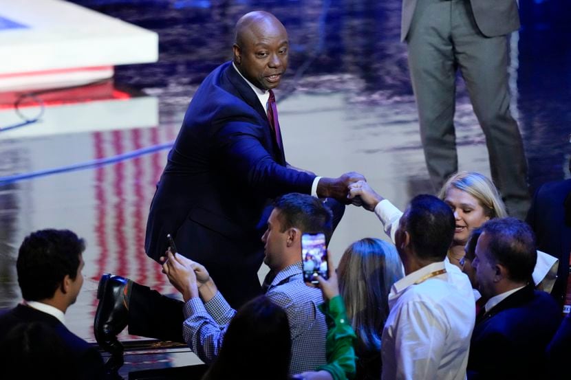 Republican presidential candidate Sen. Tim Scott, R-S.C., greets people after a Republican...