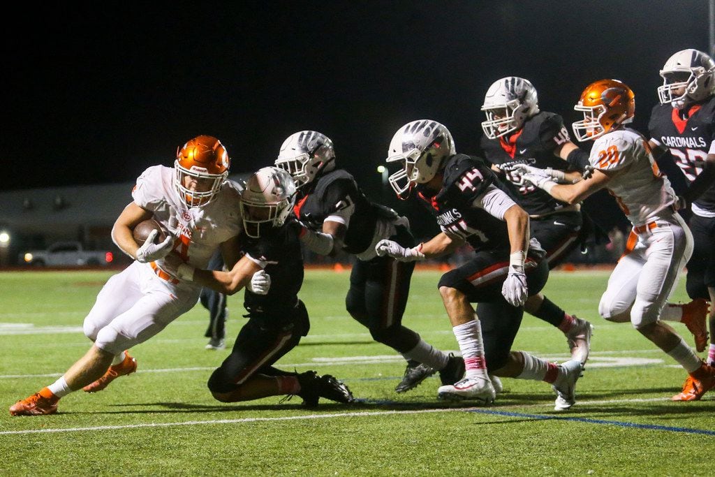 Celina running back Logan Point (4) is stopped short by Melissa defenders on a fourth and...