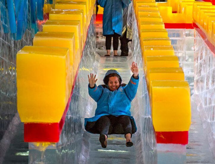 Carla Lule tries out a slide at ICE!, the annual holiday attraction at the Gaylord Texan hotel.