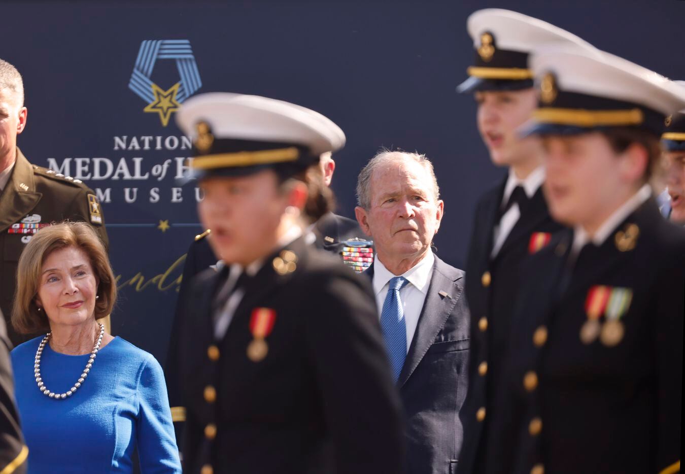 Former President George W. Bush and wife Laura listen to the U.S. Naval Academy Glee Club of...